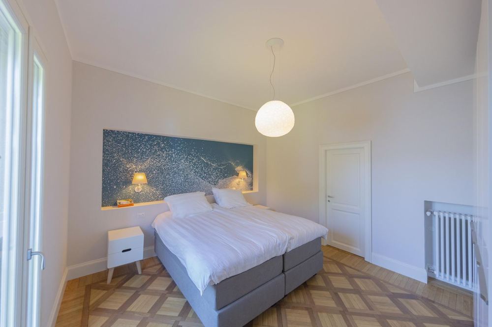 Bedroom with a lake-blue mural